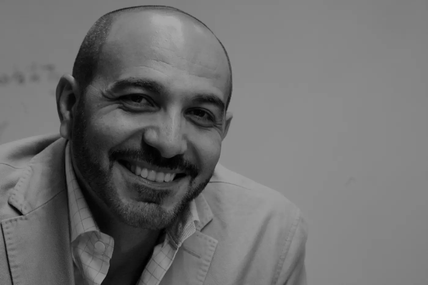 Joe Mikhail laughing, black and white